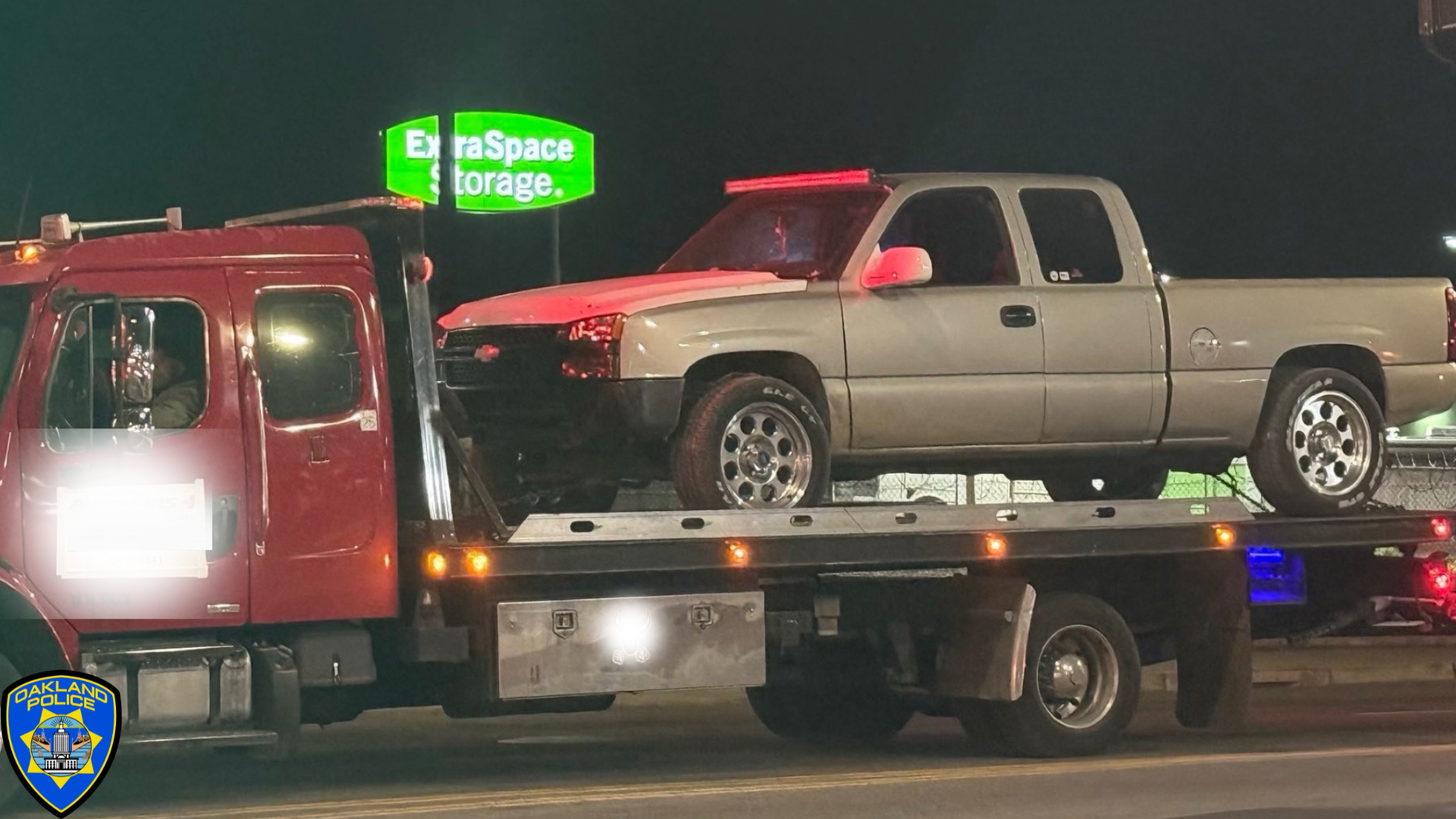 Photo of a pick up truck on the back of a flat bed tow truck