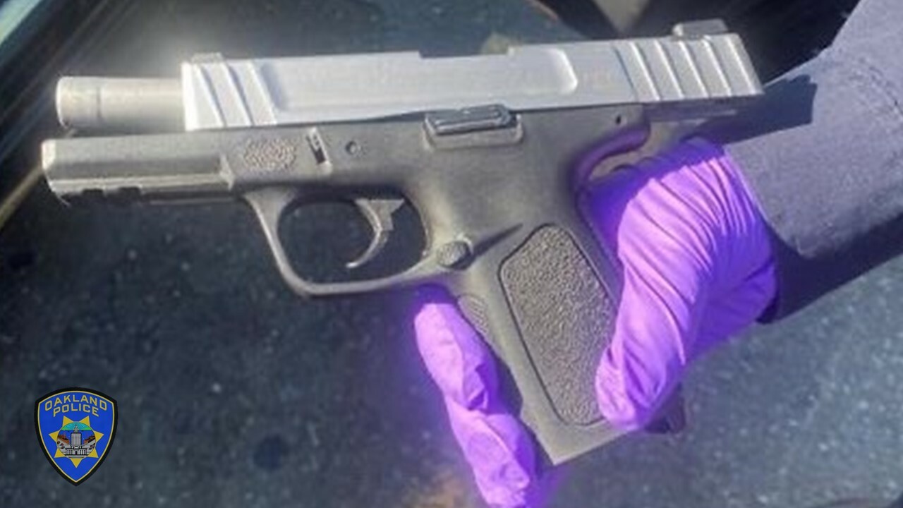 Photo of a Recovered Firearm and OPD shield