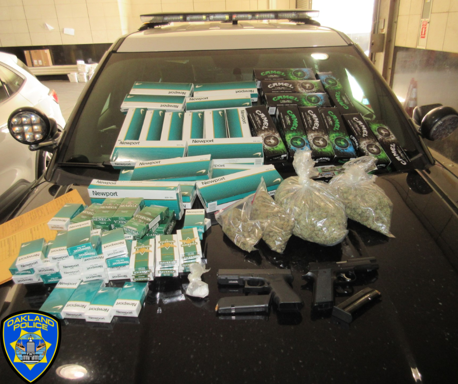 Photo of seized a large amount of illegally possessed cannabis and related products, suspected crystal methamphetamine, flavored prohibited tobacco products, and a large quantity of non-taxed cigarettes. Also two loaded firearms