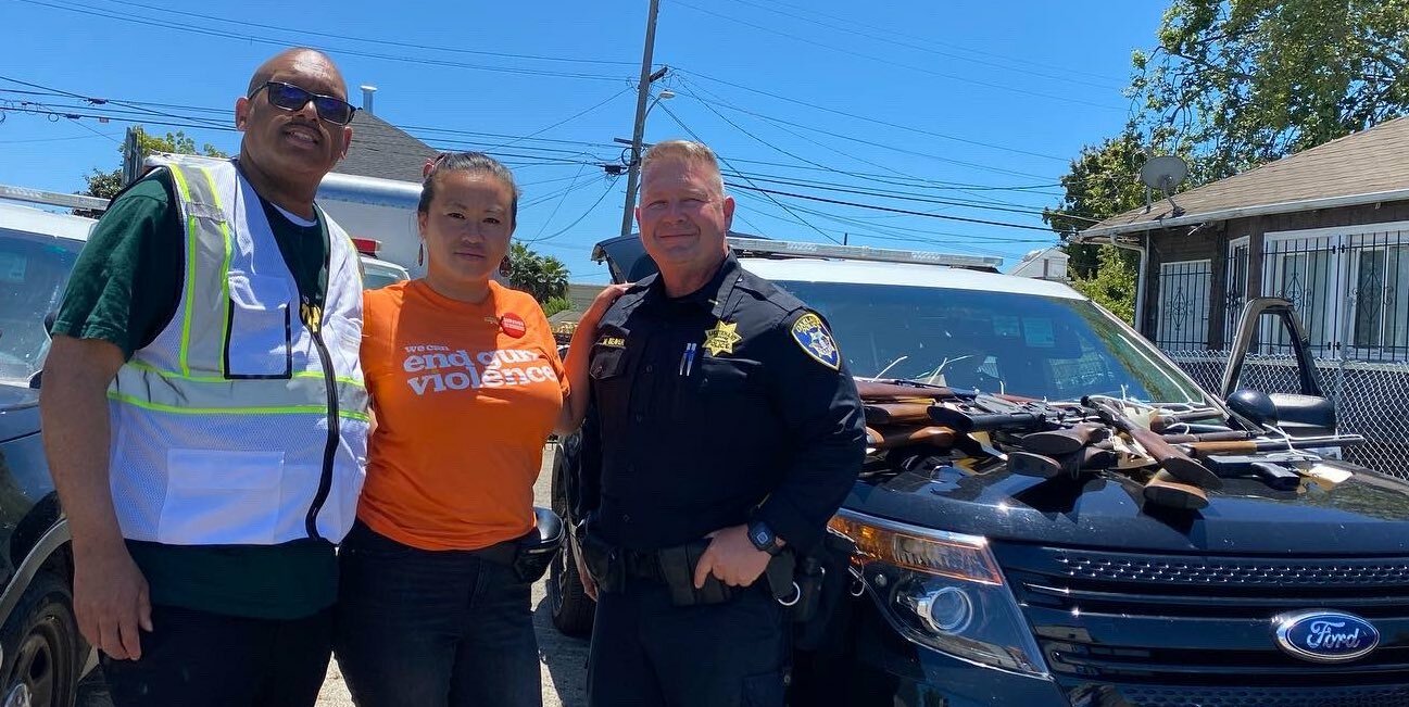 Council President Pro Tempore Sheng Thao with Pastor Billie Dixon Jr. and an OPD officer at the Guns to Gardens gun buyback event