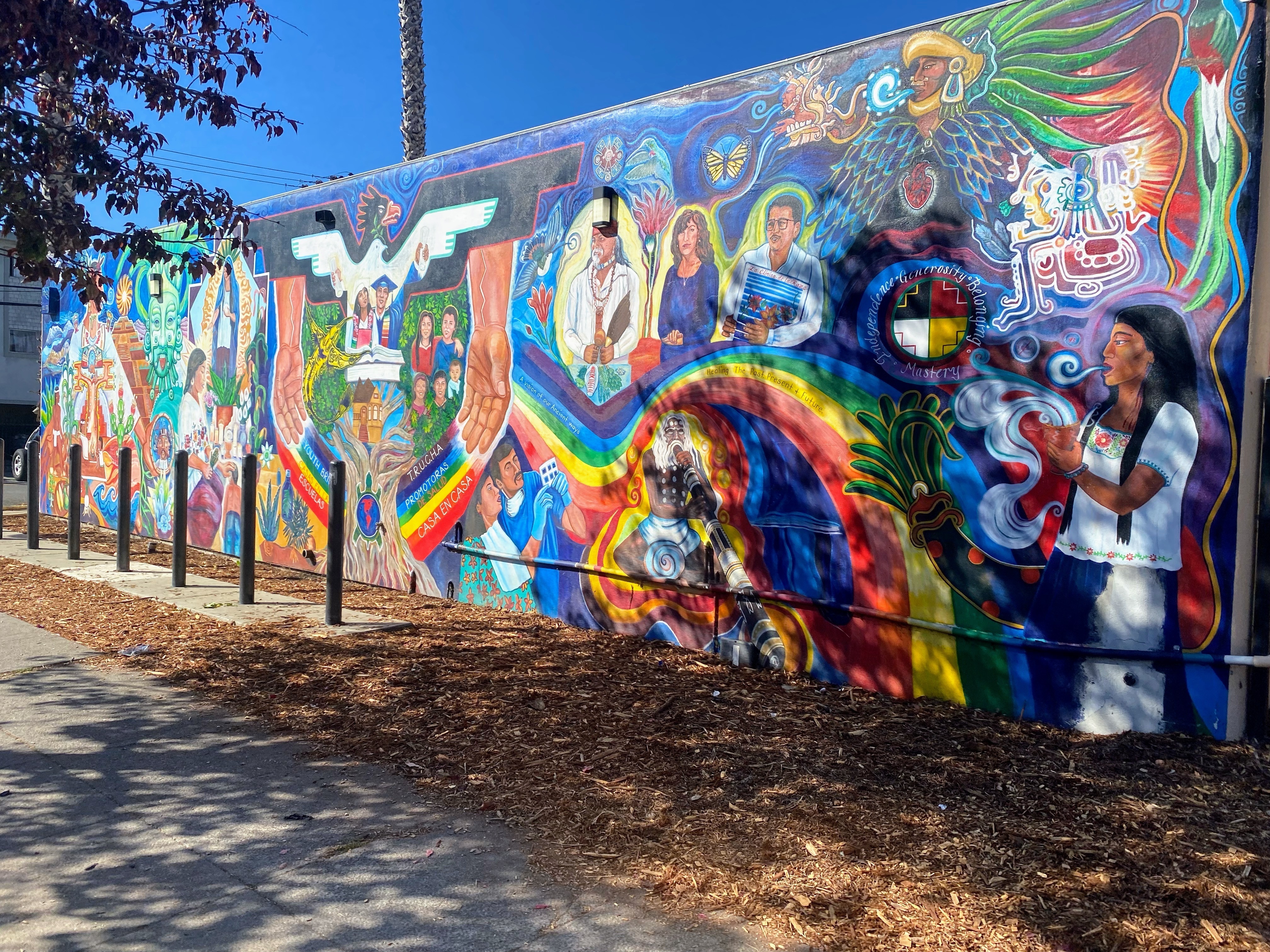 Colforul mural in Fruitvale showing  scenes of the Chicano movement of the era and of the indigenous ancestors.