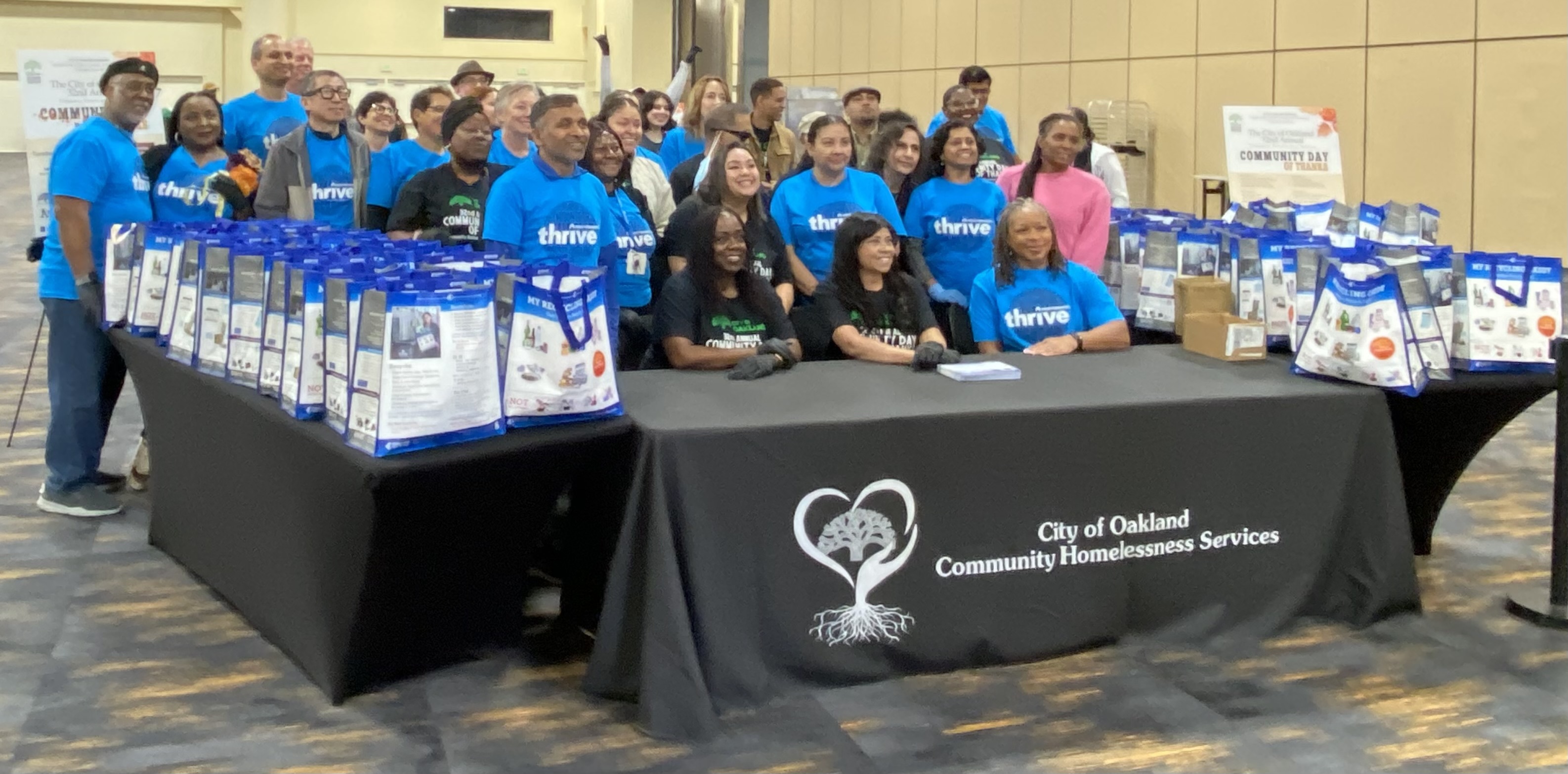 volunteers gather with blue shirts on