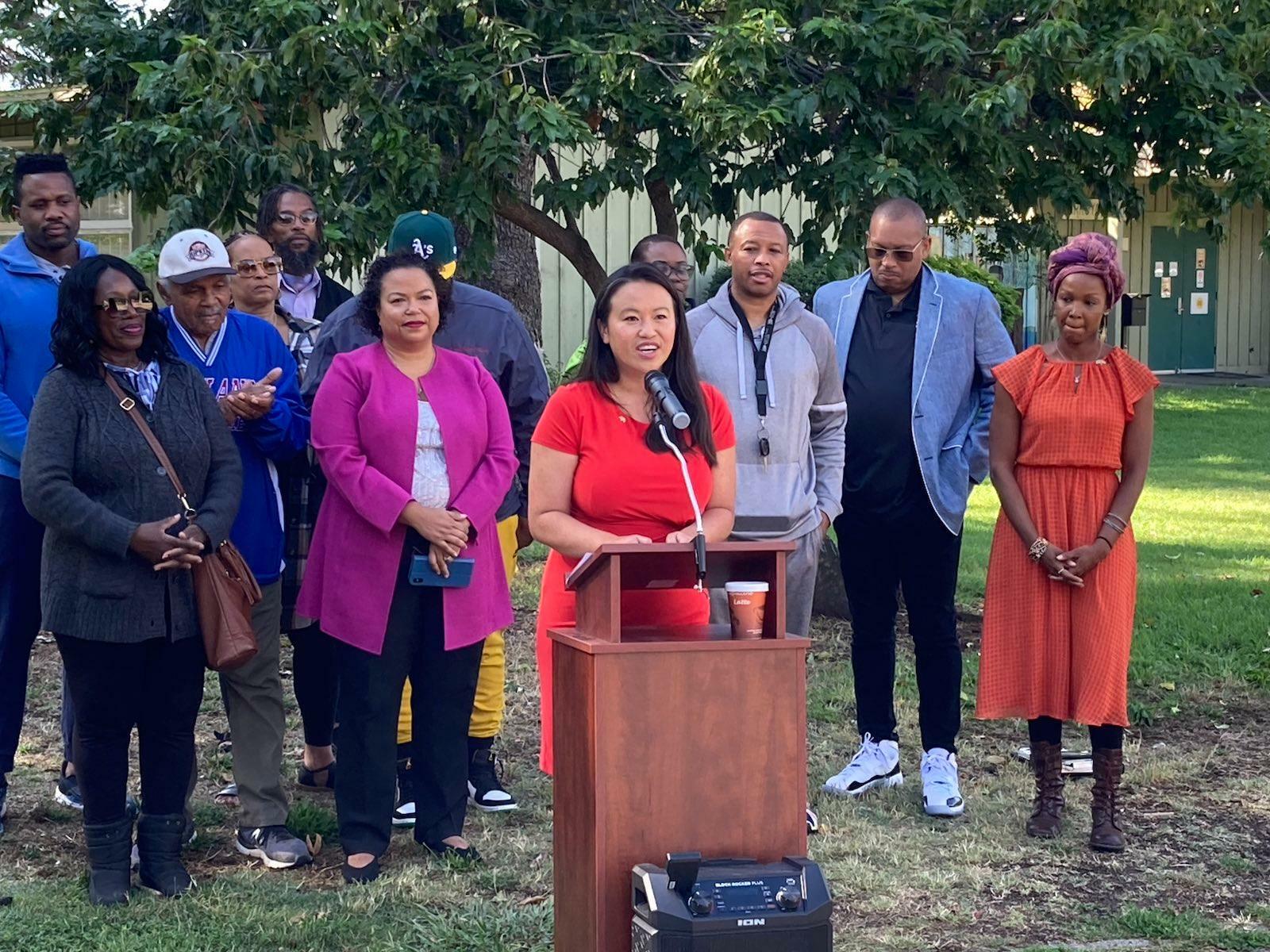 Council President Pro Tempore Sheng Thao announces a $2 million investment into East Oakland parks at a press conference surrounded by community members and Mia Bonta