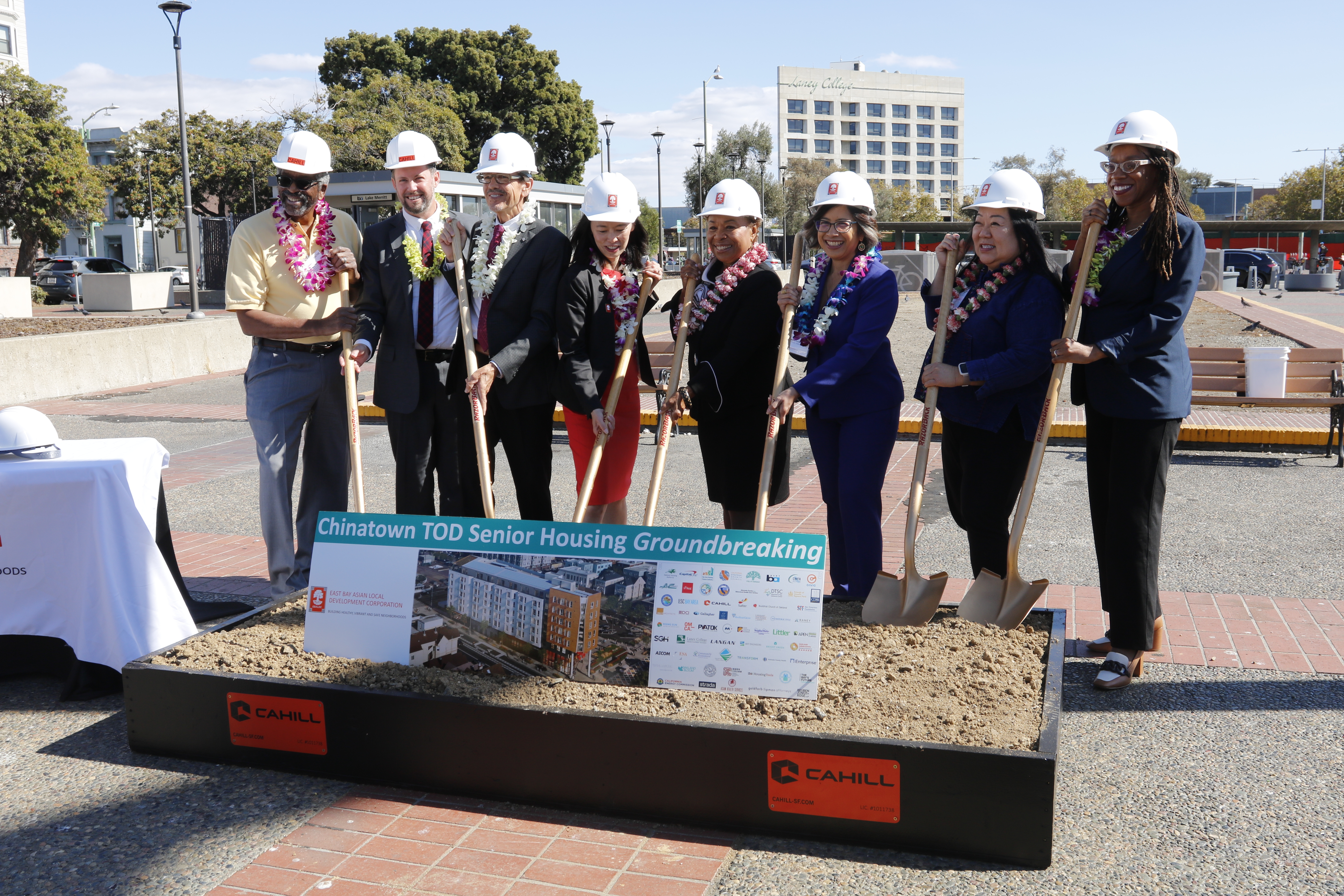 Picture of people in hard hats and shovels for groundbreaking