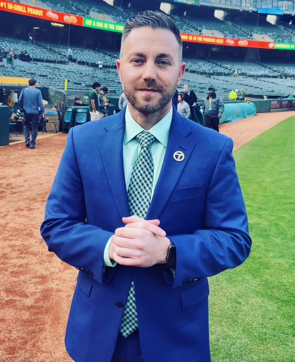 Casey Pratt poses on a baseball field