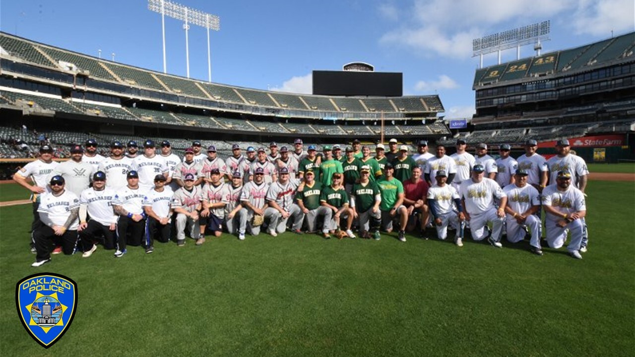 Photo of members of the Oakland Police Department (OPD), the Alameda County Sheriff’s Office, the Oakland Fire Department (OFD), and the Alameda County Fire Department at Oakland Colsieum for a softball game.