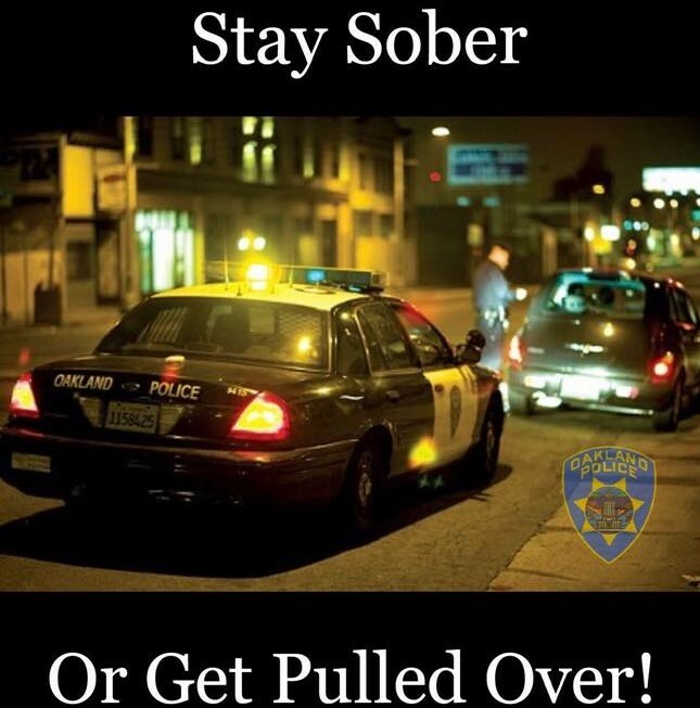 OPD Stay Sober or Get Pulled Over.  An OPD car and another vehicle with the officer speaking to the driver.